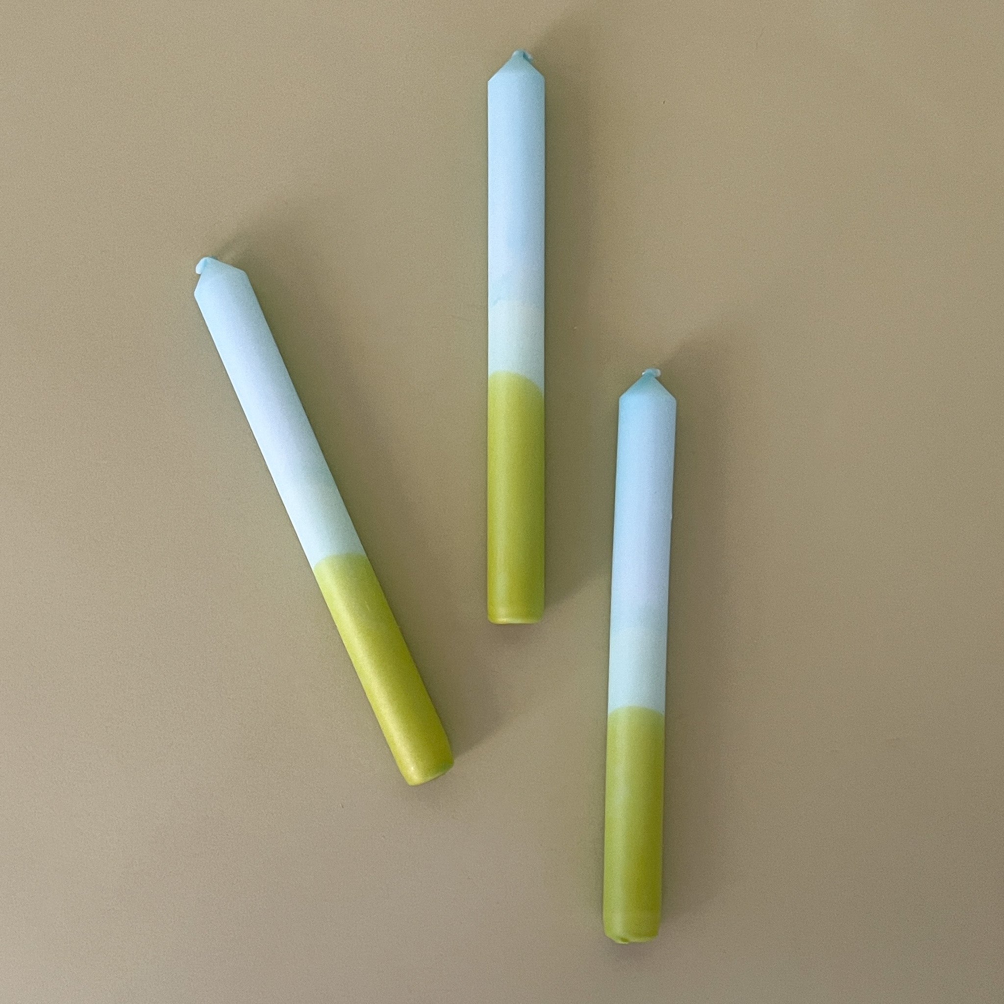 three blue and green taper candles