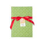 Elegant gift wrap featuring delicate white floral patterns on a vibrant green background for beautiful presents.