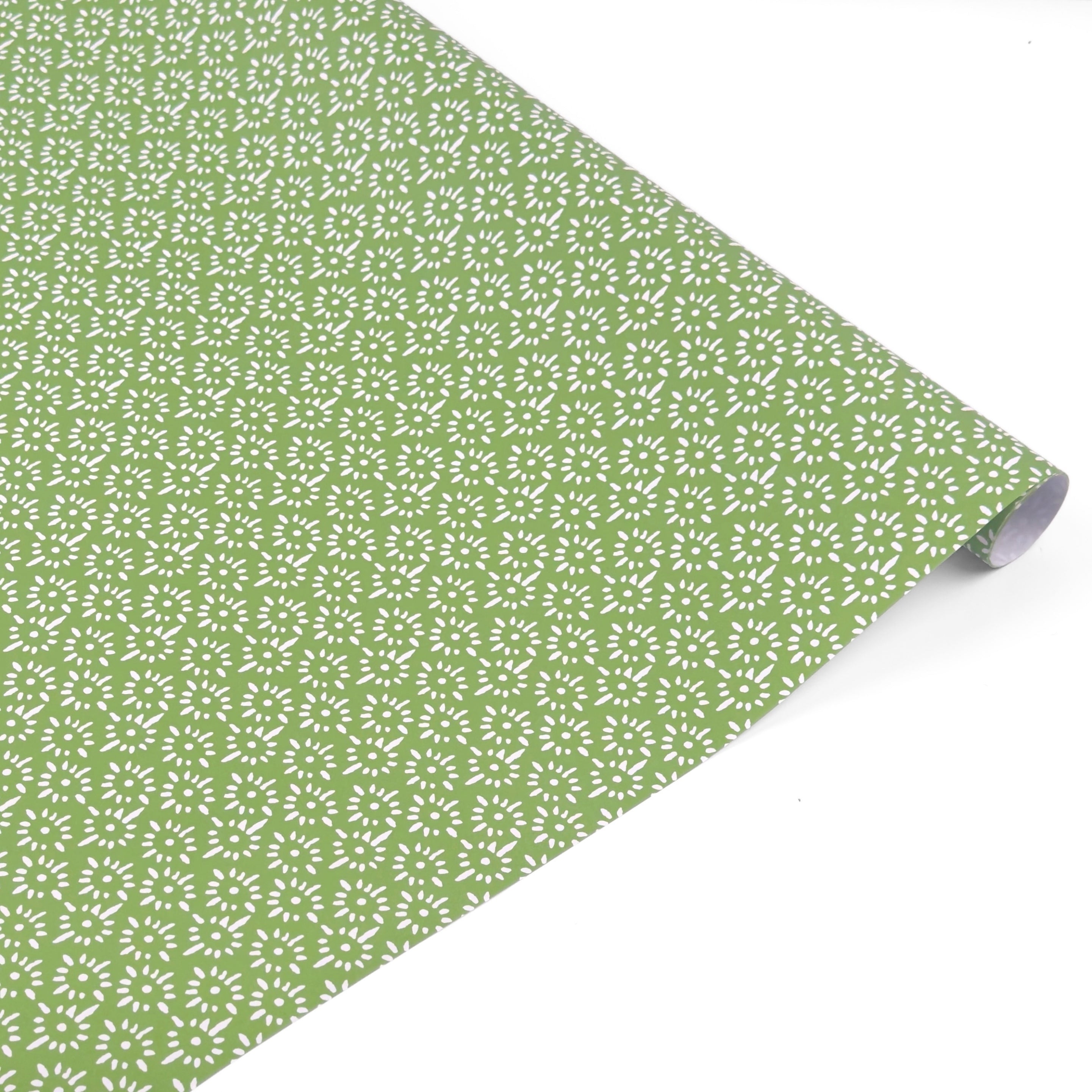Elegant gift wrap roll featuring delicate white floral patterns on a soft green background for gifting.
