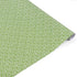 Elegant gift wrap roll featuring delicate white floral patterns on a soft green background for gifting.