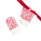 Toujours Provence pink floral gift tags featuring printed To and From fields, with one tag attached to a vibrant red satin ribbon.