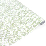 Elegant gift wrap featuring delicate green floral patterns on white paper, perfect for thoughtful gifting.