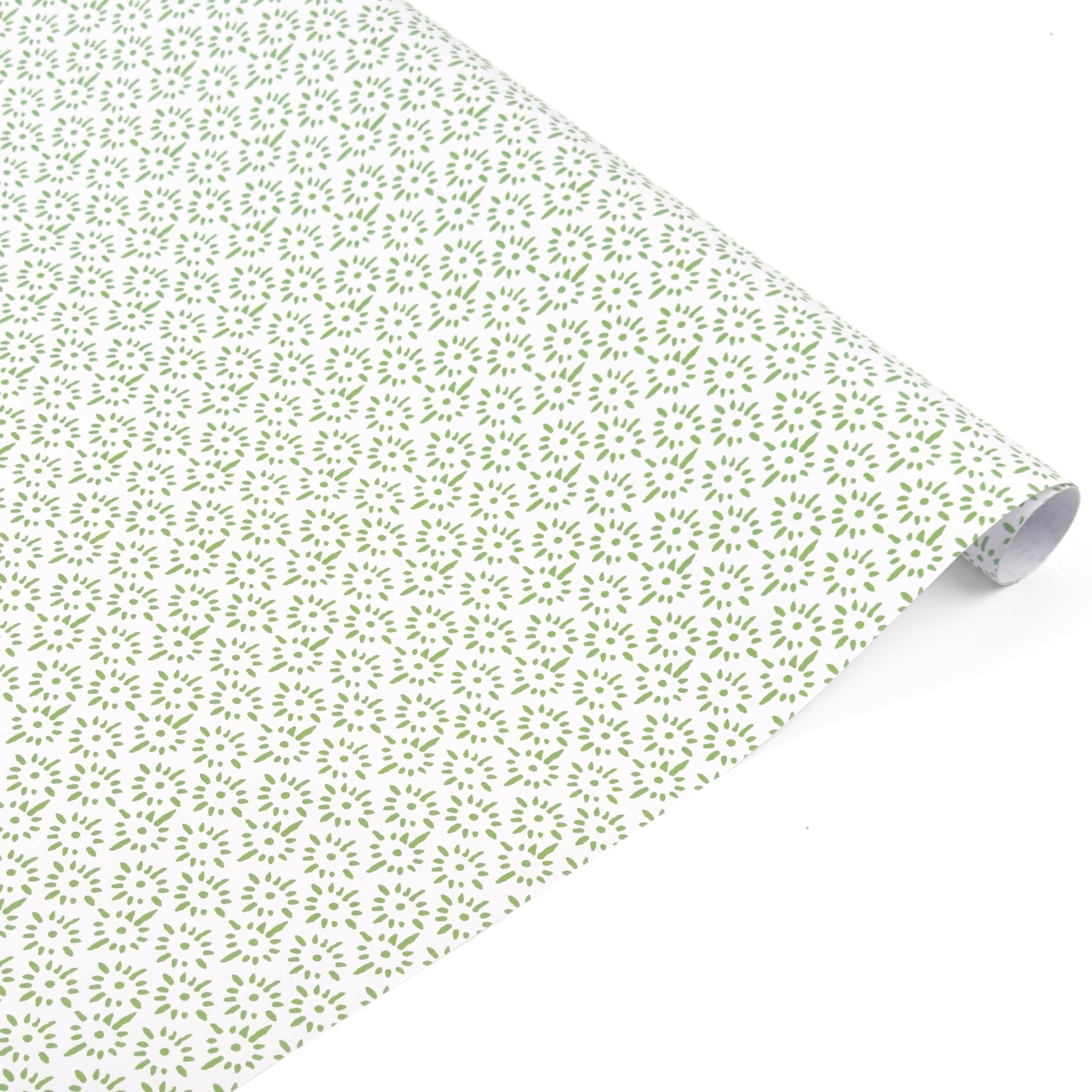Elegant gift wrap featuring delicate green floral patterns on white paper, perfect for thoughtful gifting.