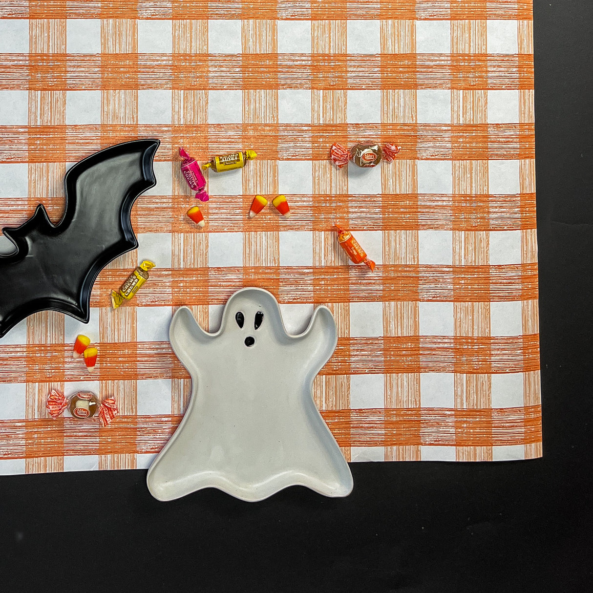 a gingham orange paper table runner in a pattern called gin lane by madcap cottage