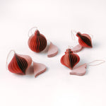 Set of folded paper pink Christmas ornaments in assorted bulb shapes with hanging string