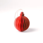 Close-up of pink folded paper Christmas ornaments in assorted bulb and teardrop shapes with hanging strings