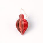Close-up of pink folded paper Christmas ornaments in assorted bulb and teardrop shapes with hanging strings
