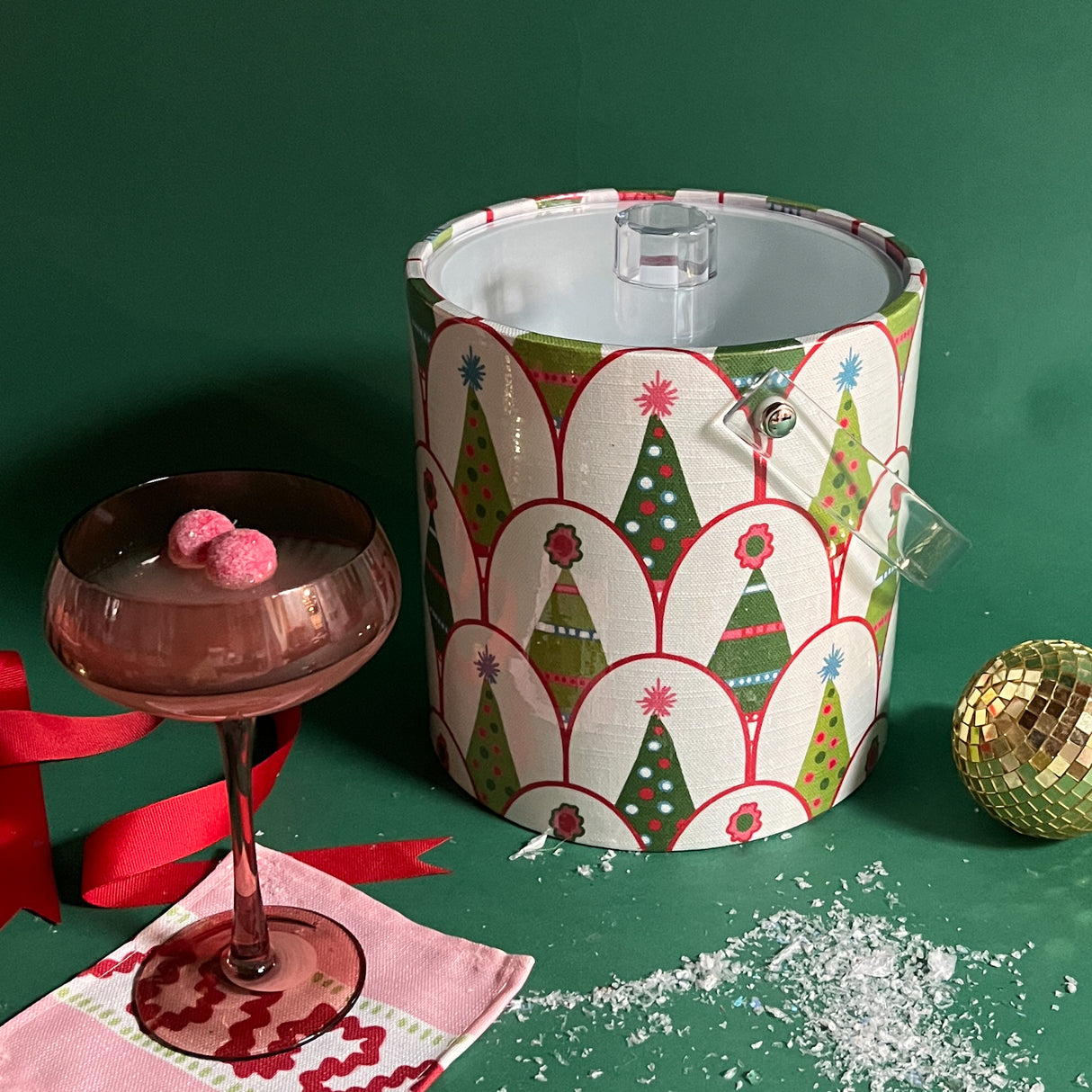 An acrylic ice bucket covered in a green Christmas tree pattern.