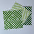 White and green paper placemats featuring a white bamboo pattern called Island House by Madcap Cottage