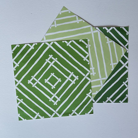 White and green paper placemats featuring a white bamboo pattern called Island House by Madcap Cottage