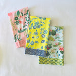 a trio of pink, yellow and blue chinoiserie tea towels. 