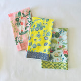 a trio of pink, yellow and blue chinoiserie tea towels. 