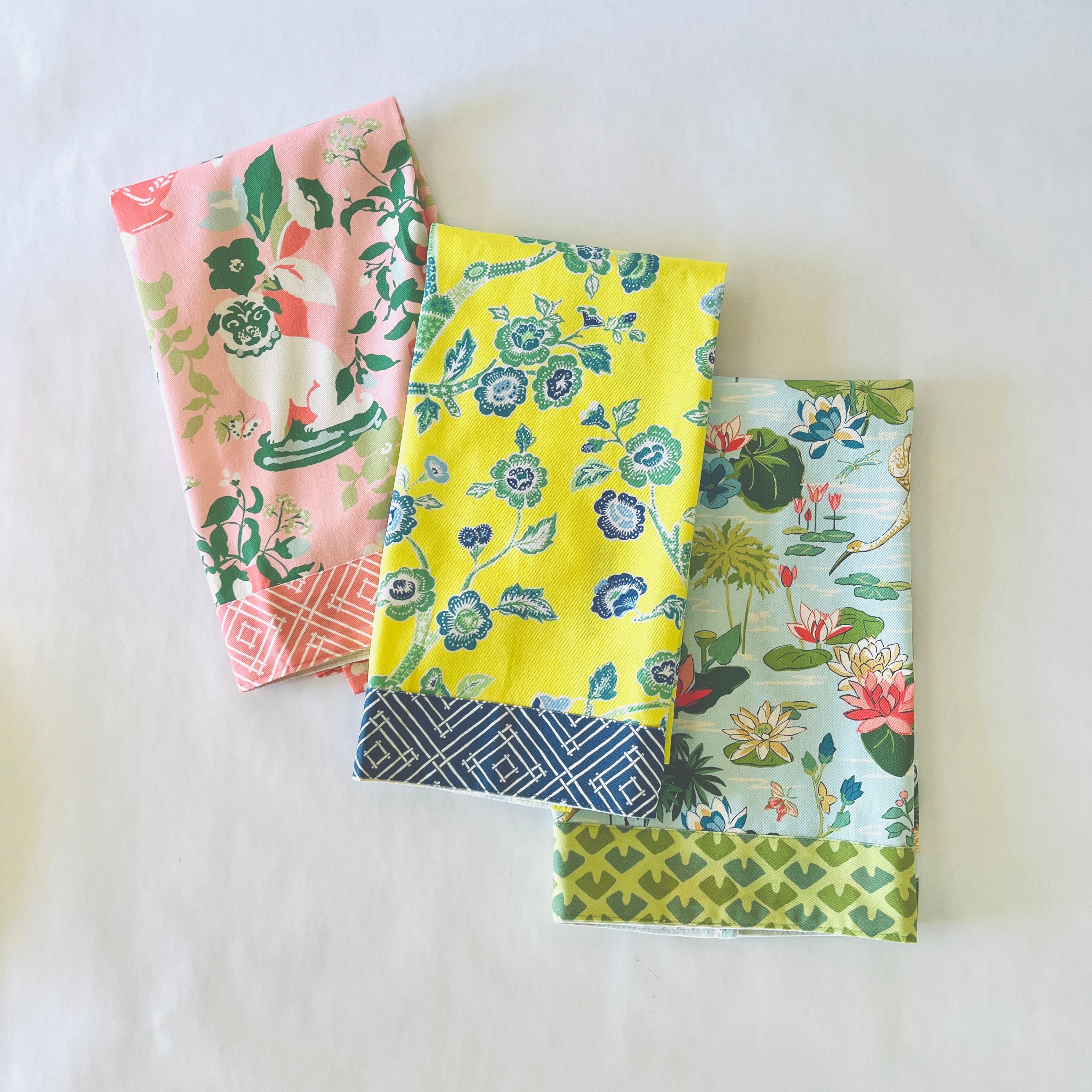 a trio of pink, yellow and blue chinoiserie tea towels. 