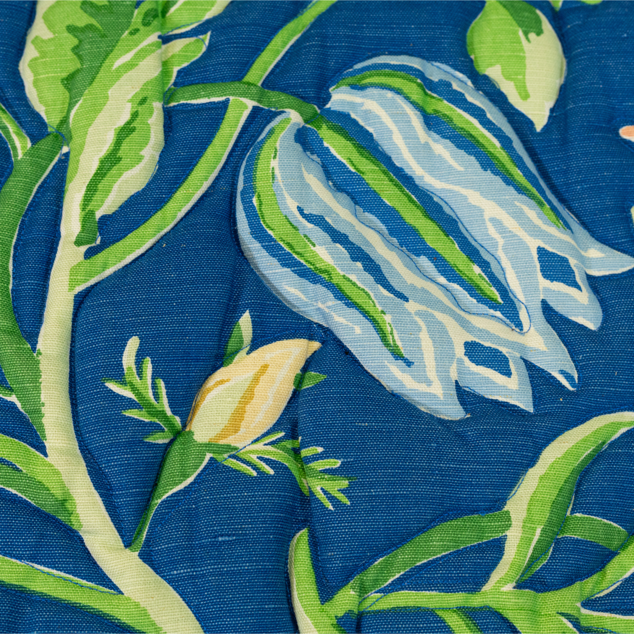 Blue floral upholstered loveseat with botanical pattern and rolled arms