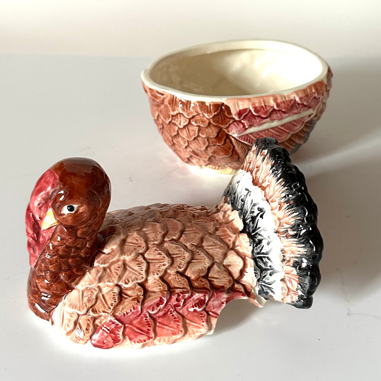 a ceramic turkey centerpiece in two parts resting on a white background