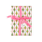 Festive Christmas gift wrap featuring colorful decorated trees, playful patterns, and cheerful pink ribbon accents.