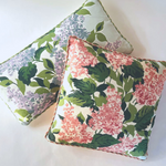a square throw pillow and a rectangular throw pillow made from hydrangea print fabric.