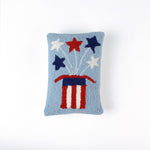 Rectangular light blue pillow featuring a red, white, and blue Uncle Sam hat with stars bursting from the top, symbolizing a patriotic USA theme.