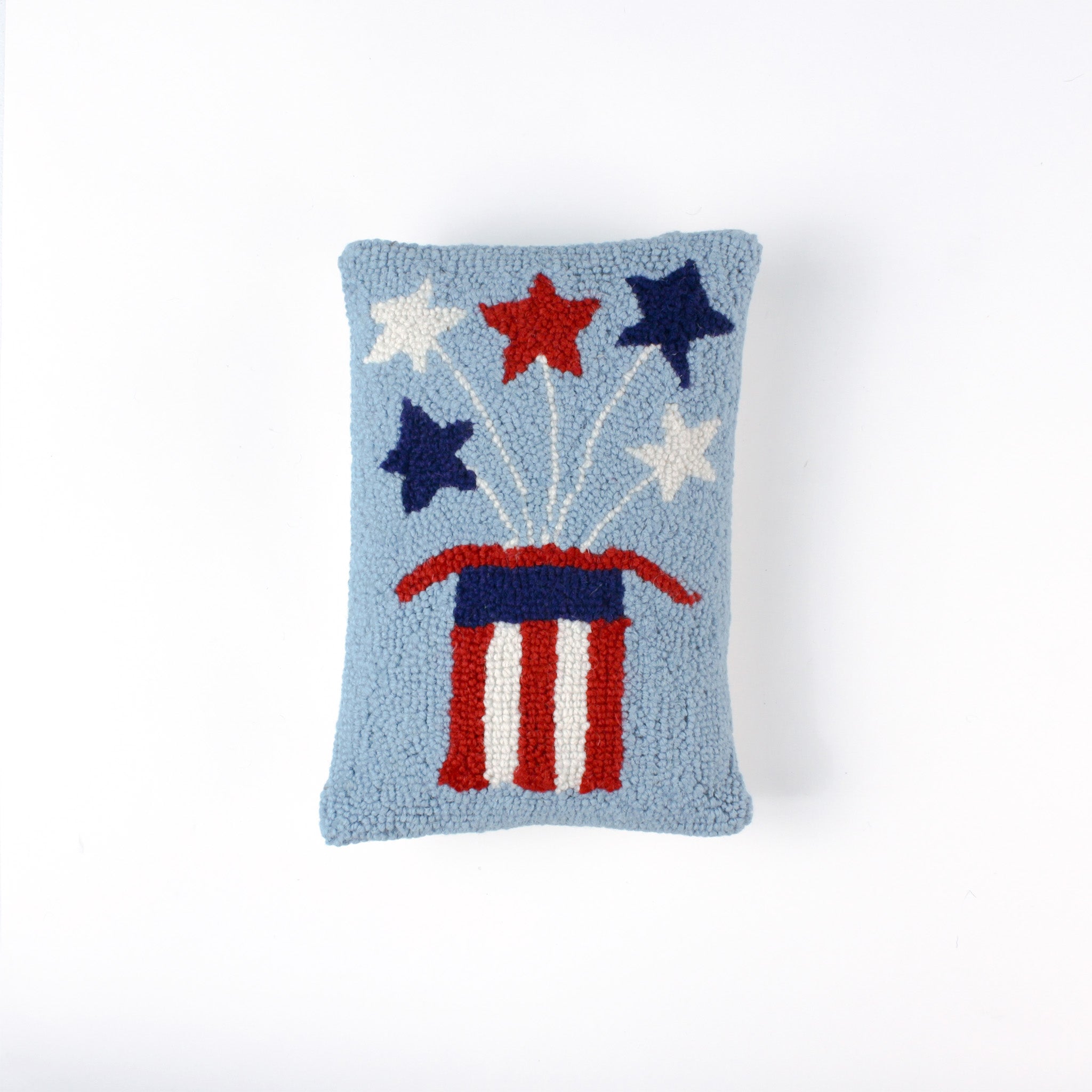 Rectangular light blue pillow featuring a red, white, and blue Uncle Sam hat with stars bursting from the top, symbolizing a patriotic USA theme.
