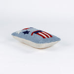 Rectangular light blue pillow featuring a red, white, and blue Uncle Sam hat with stars bursting from the top, symbolizing a patriotic USA theme.