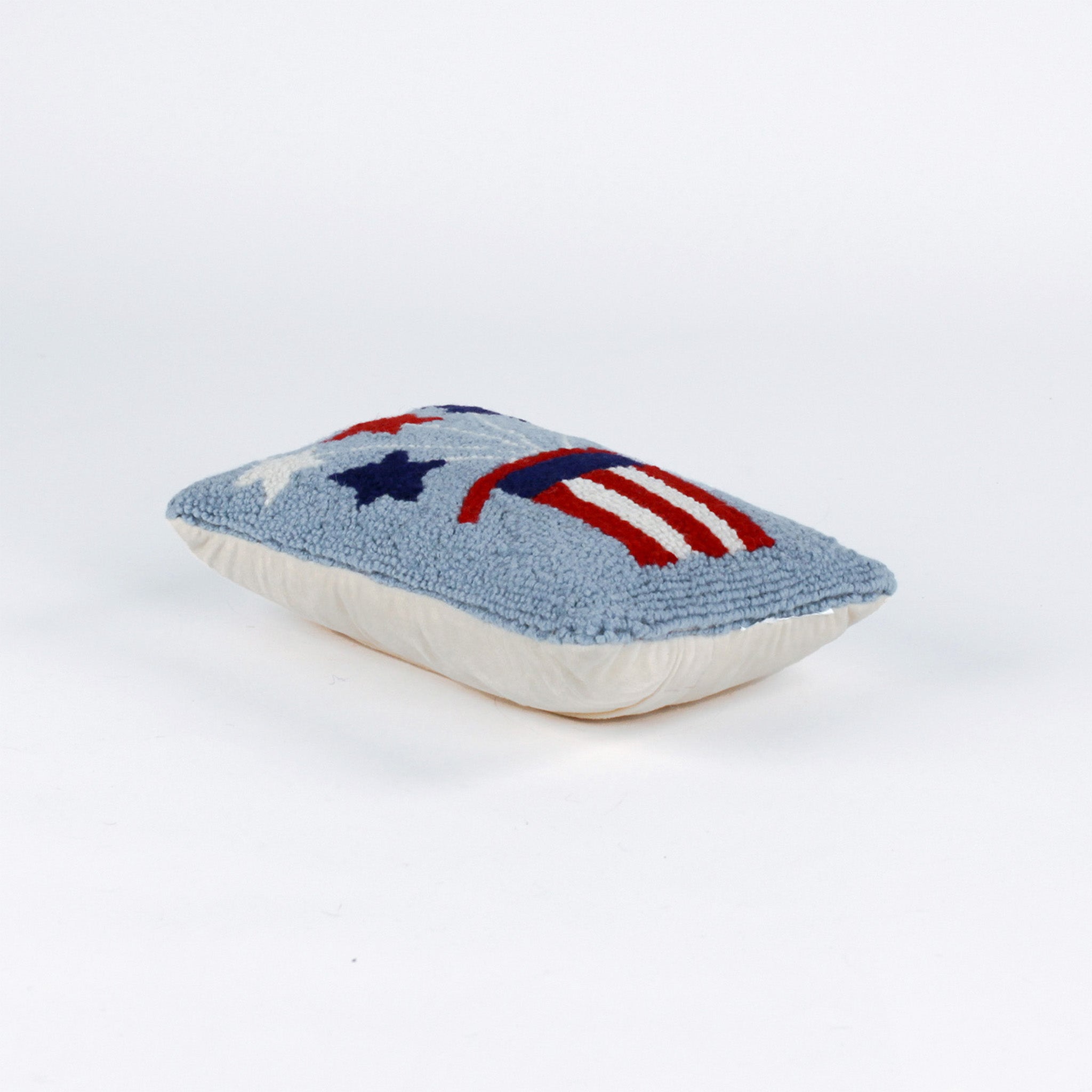 Rectangular light blue pillow featuring a red, white, and blue Uncle Sam hat with stars bursting from the top, symbolizing a patriotic USA theme.