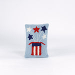 Rectangular light blue pillow featuring a red, white, and blue Uncle Sam hat with stars bursting from the top, symbolizing a patriotic USA theme.
