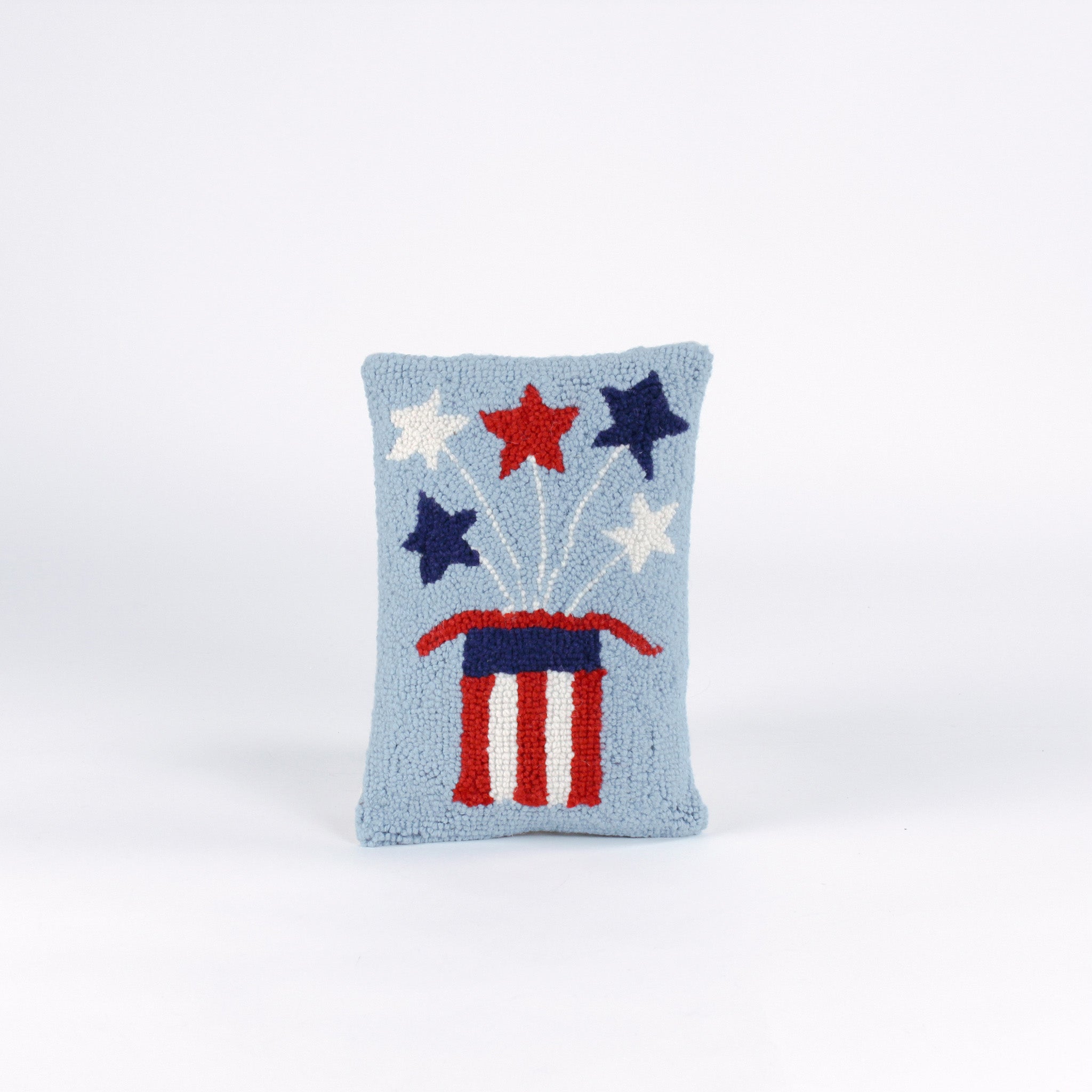 Rectangular light blue pillow featuring a red, white, and blue Uncle Sam hat with stars bursting from the top, symbolizing a patriotic USA theme.