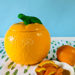 a large orange shaped cookie jar