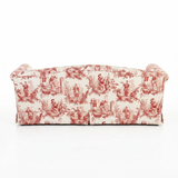 The back view of a sofa upholstered in a red and cream toile pattern, shown from the back against a plain white background.