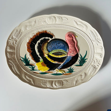 a white ceramic vintage turkey platter on a plain white backroung
