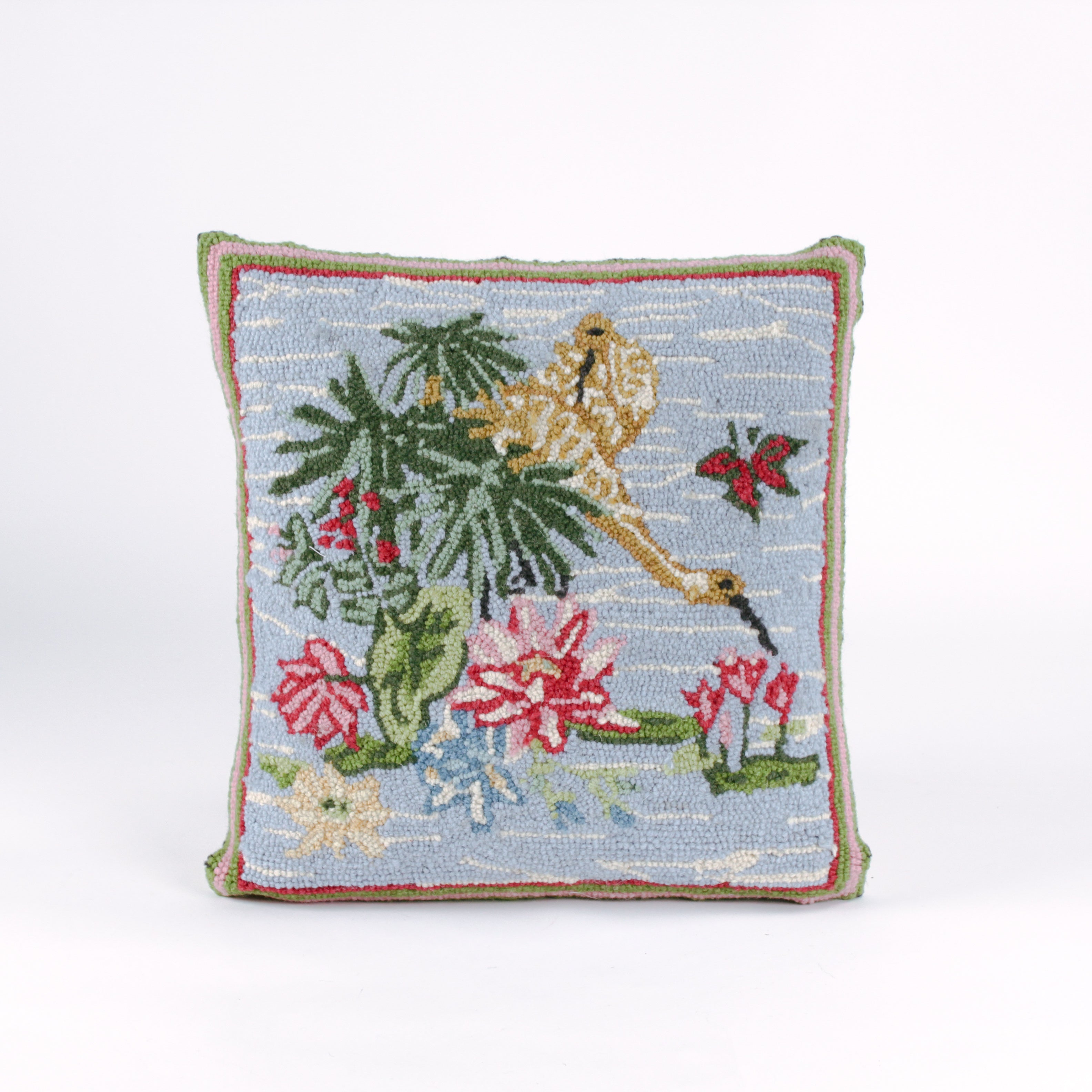 Square decorative pillow with a hooked design featuring a yellow crane standing among green leaves and pink water lilies on a light blue background with a butterfly flying nearby.