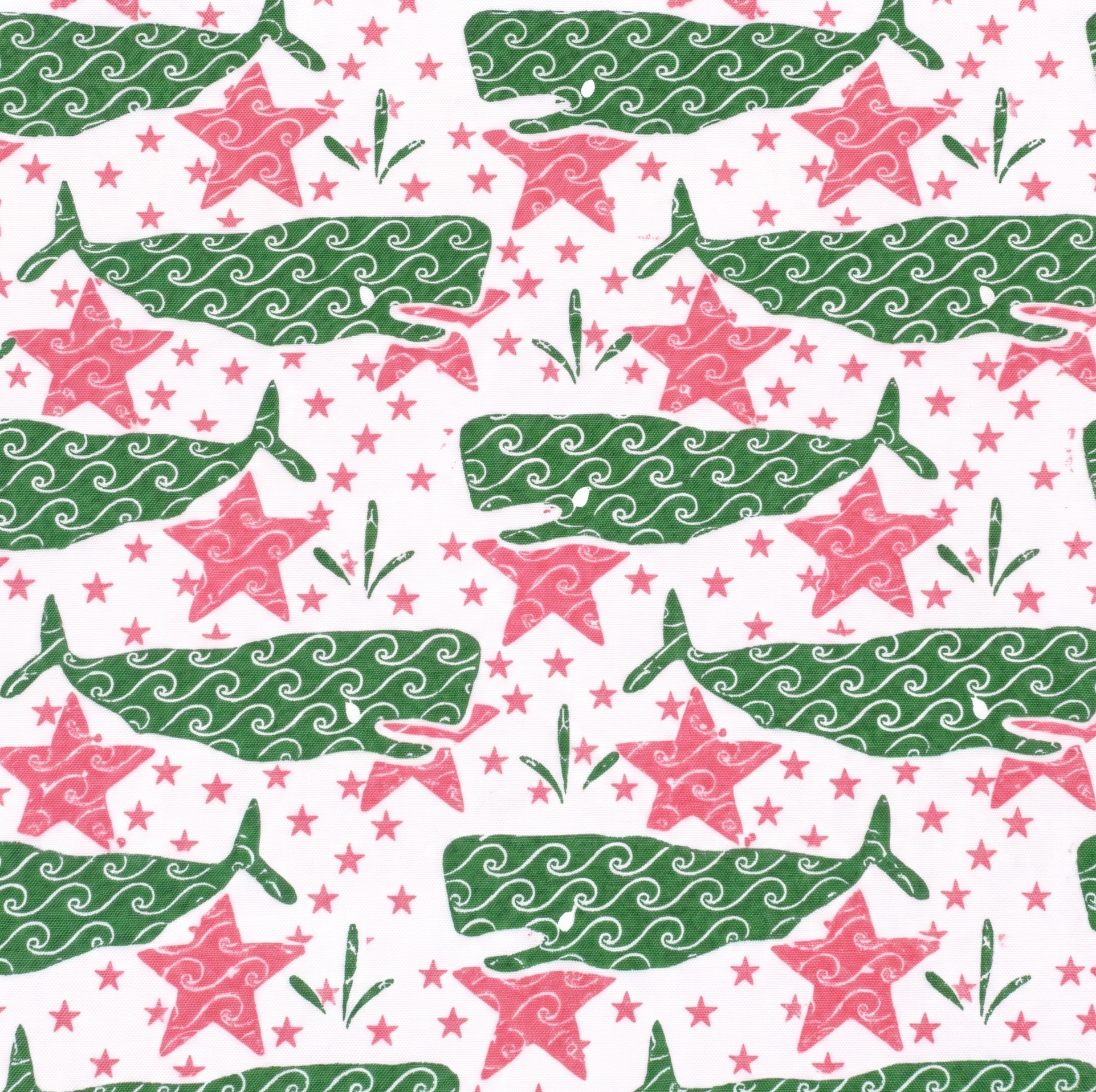white wallpaper with a repeating green whale and pink star motif. 