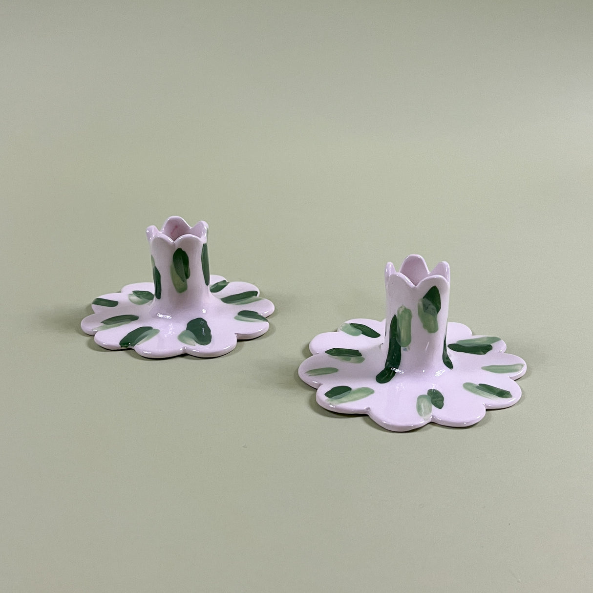 a pair of madcap cottage ceramic candle holders with scalloped edges and a green brushstroke print