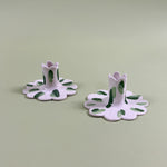 a pair of madcap cottage ceramic candle holders with scalloped edges and a green Club House print