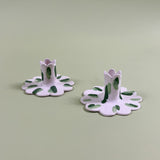 a pair of madcap cottage ceramic candle holders with scalloped edges and a green Club House print