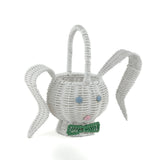 front side view of white wicker bunny basket with handle on white background