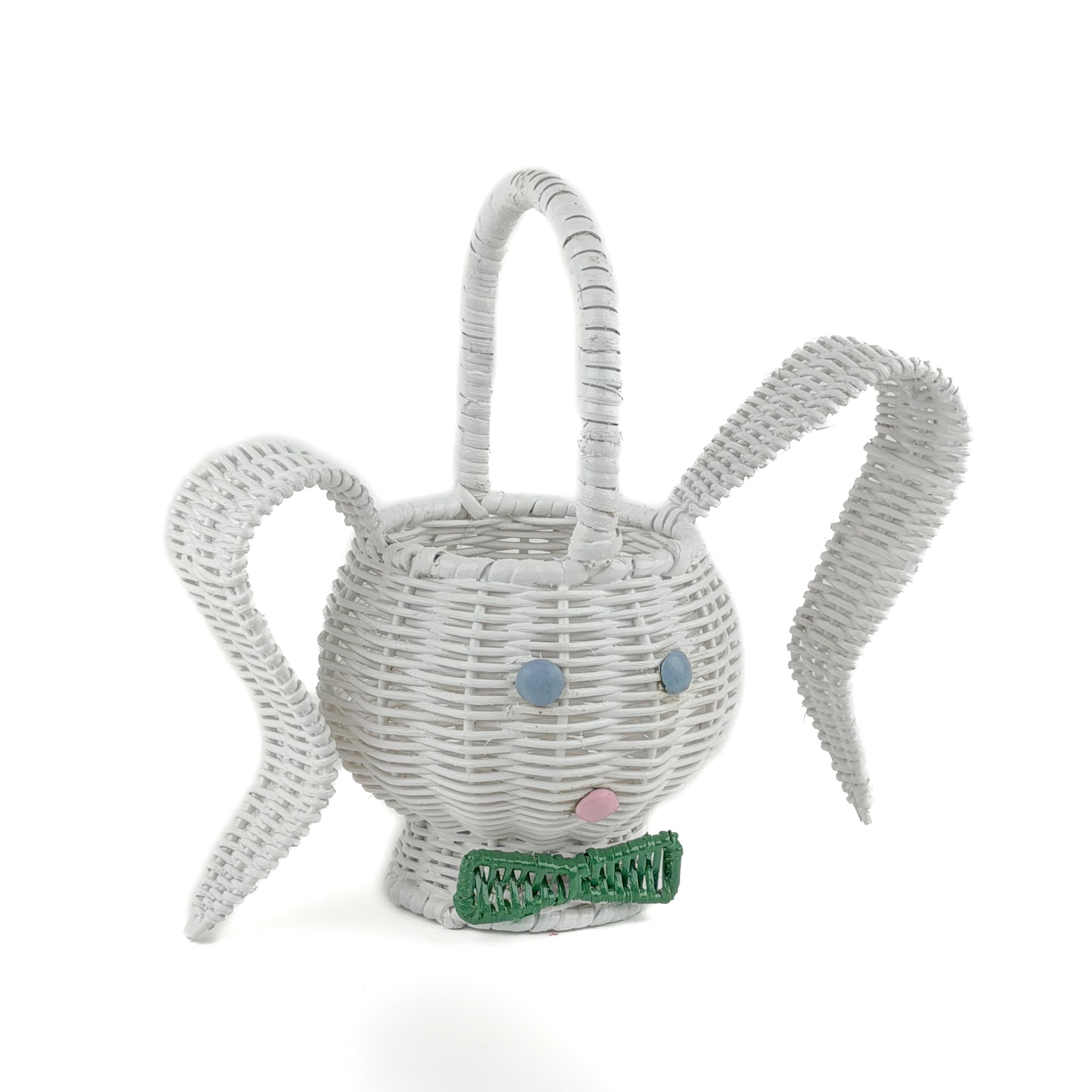 front side view of white wicker bunny basket with handle on white background