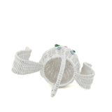 top view of white wicker bunny basket with handle on white background