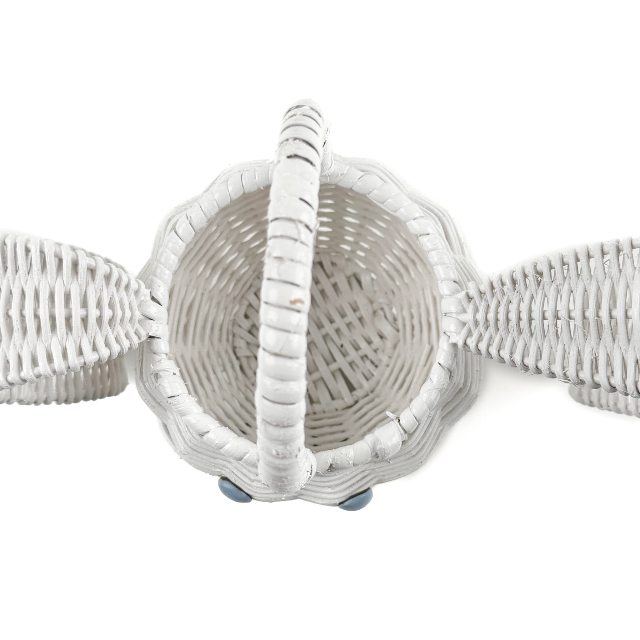 top-view of white wicker bunny basket with handle on white background