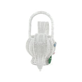 side view of white wicker bunny basket with handle on white background