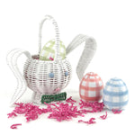 white wicker bunny Easter basket with plaid eggs and pink filler on white background