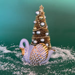 a Vintage White/Gold Ceramic Swan w/Gold Christmas Tree Centerpiece against a green background. 