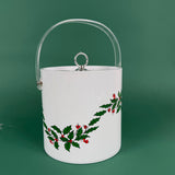White Christmas ice bucket with holly and red berry design and a clear handle on a green background