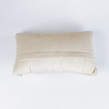 back of a Rectangular white pillow with a hooked wool design of two crossed red and blue pickleball paddles and a yellow pickleball above them.