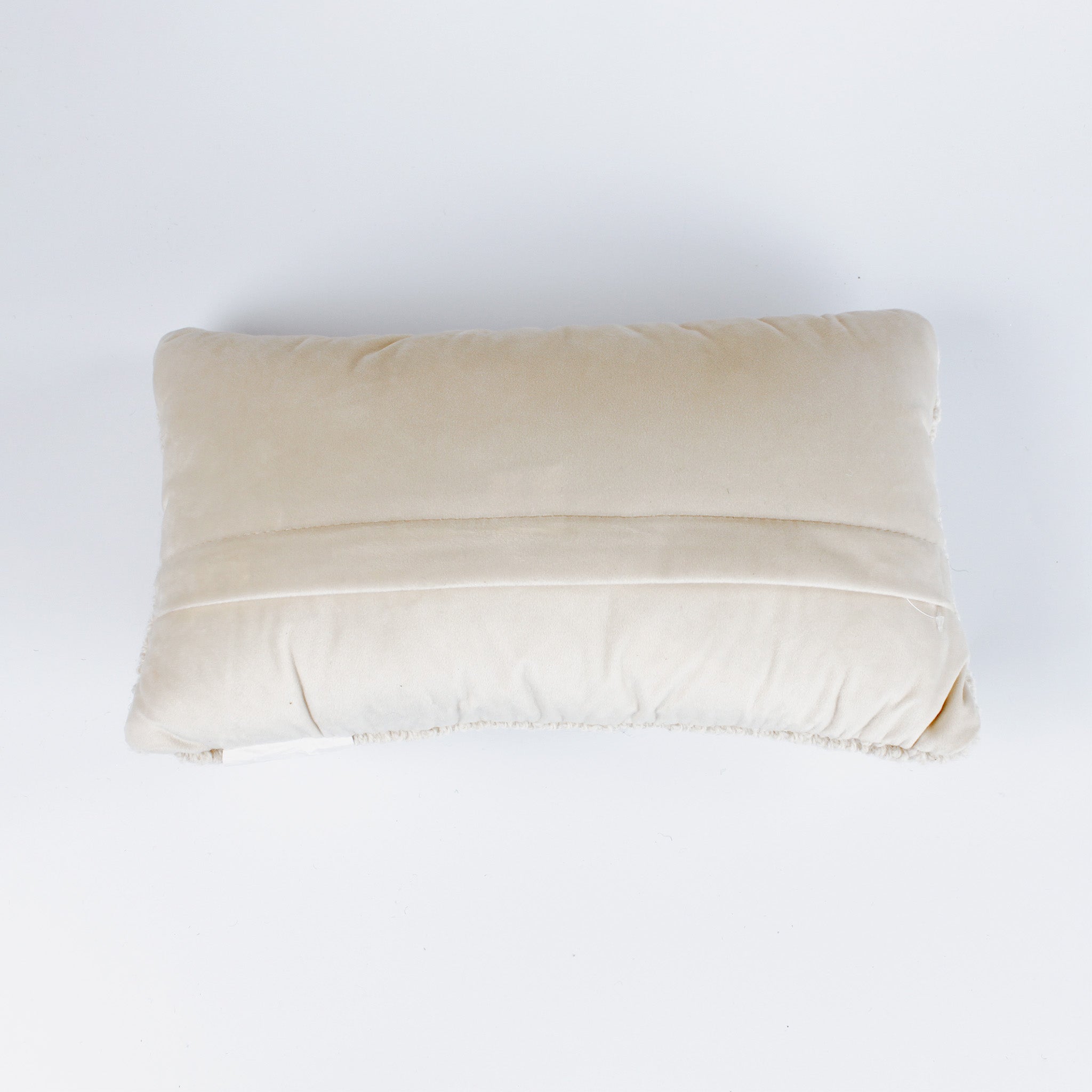 back of a Rectangular white pillow with a hooked wool design of two crossed red and blue pickleball paddles and a yellow pickleball above them.