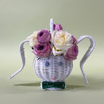 white rattan bunny easter basket with flowers in it
