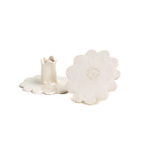 Pair of white ceramic candle holders with scalloped bases and fluted candle cups, photographed on a white background.