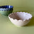 white scalloped ceramic bowl by madcap cottage