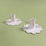 pair of white scalloped ceramic candleholders