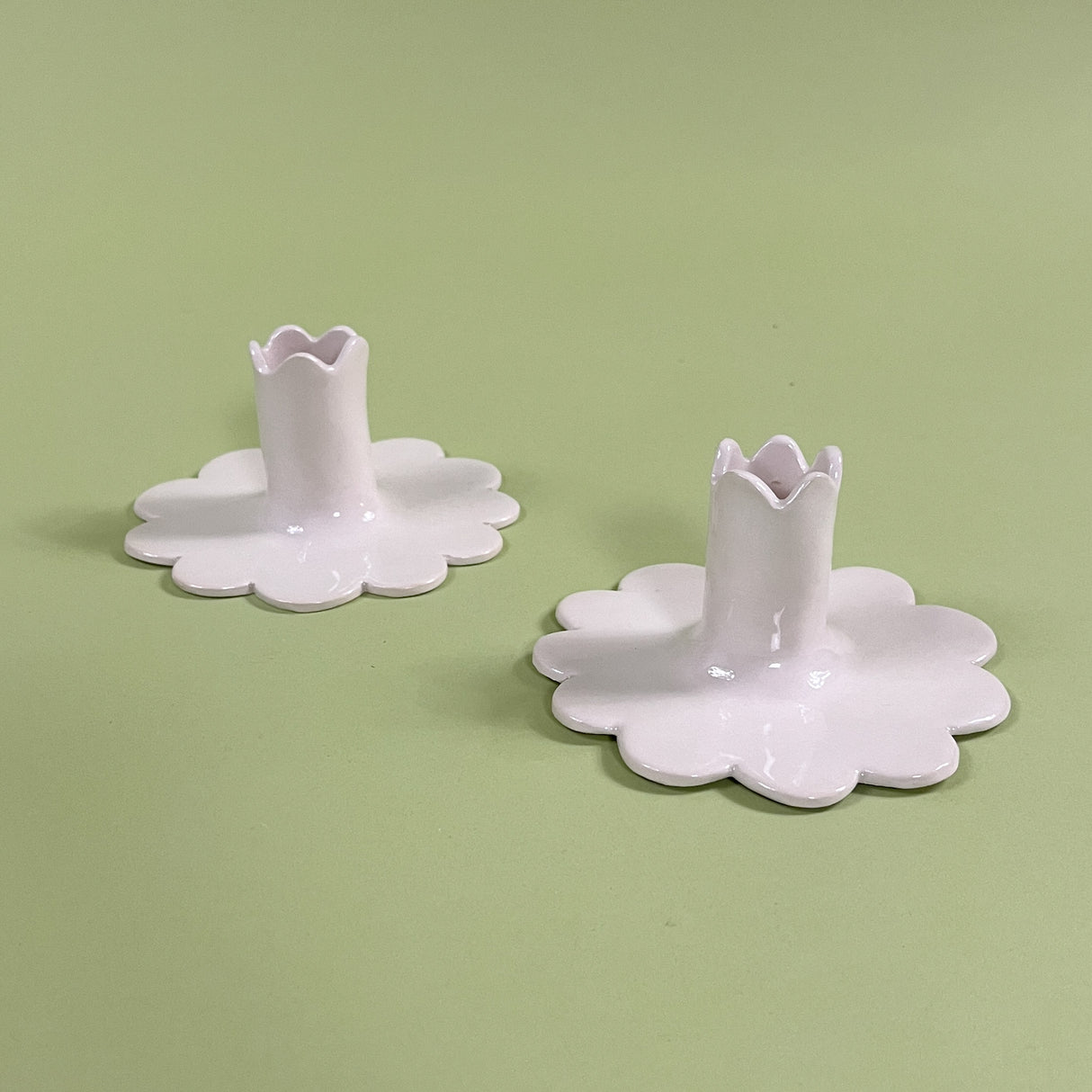 pair of white scalloped ceramic candleholders